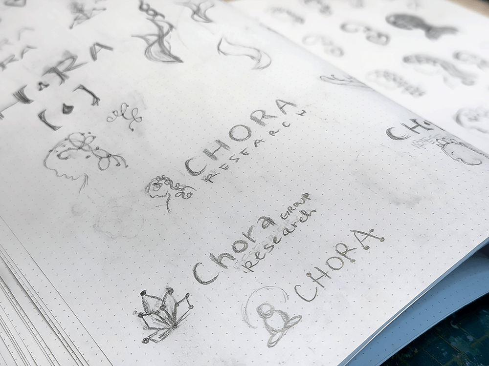 sketch book with early versions of logo