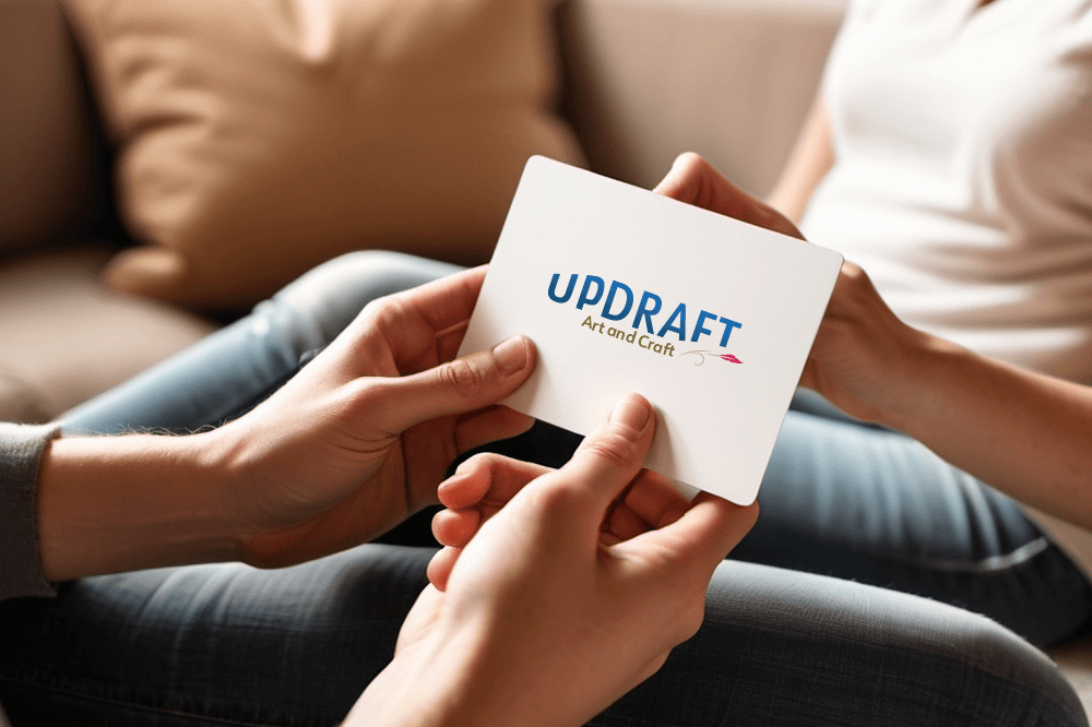 Hands holding card with updraft logo
